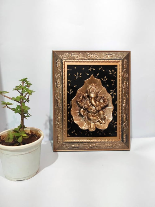 Ganesha sitting on a leaf in a flower design frame glossy look, Ganesh Frame Wall Hanging or even keep it on the table Decor for Living Room, Bedroom, Pooja Room, Dining Room, Office, Home Decoration